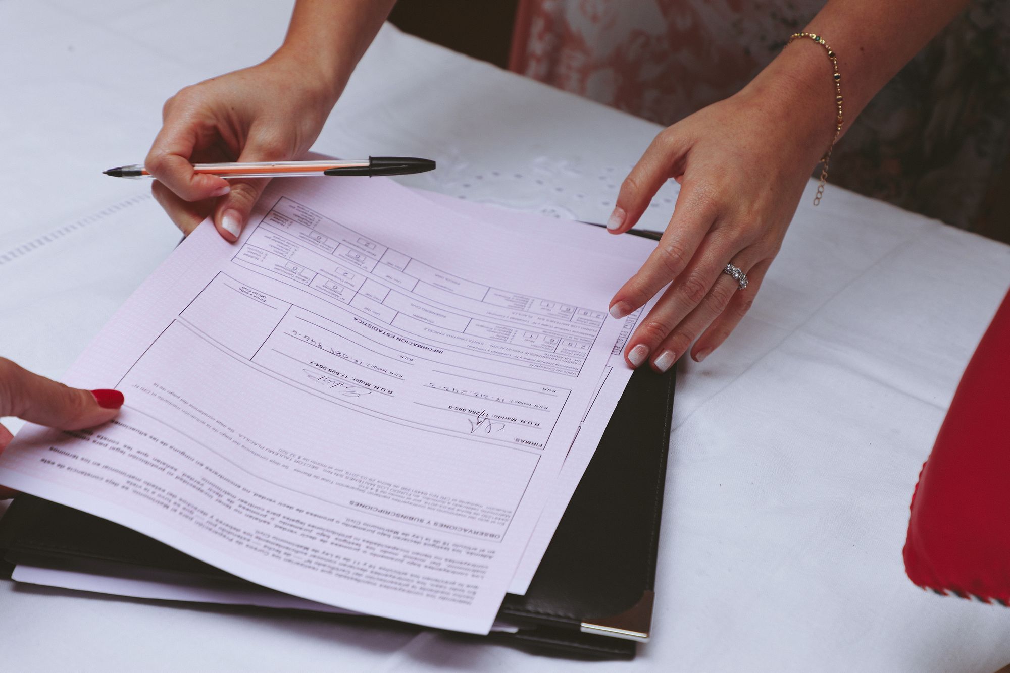 Careful hands preparing a document at a desk